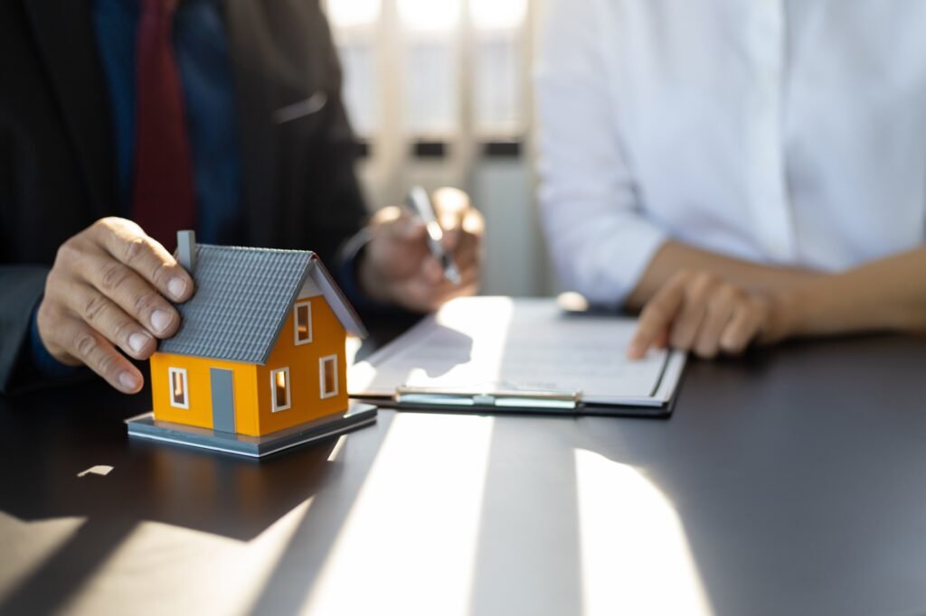 Insurance agent consulting real estate insurance detail to customer.